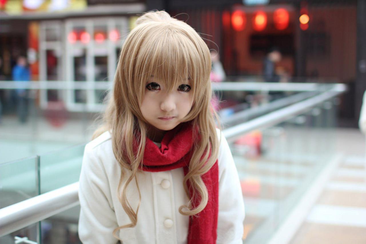 逢坂大魔王_AOI扮演逢坂大河穿着米色呢子大衣，围着红色围巾在商场