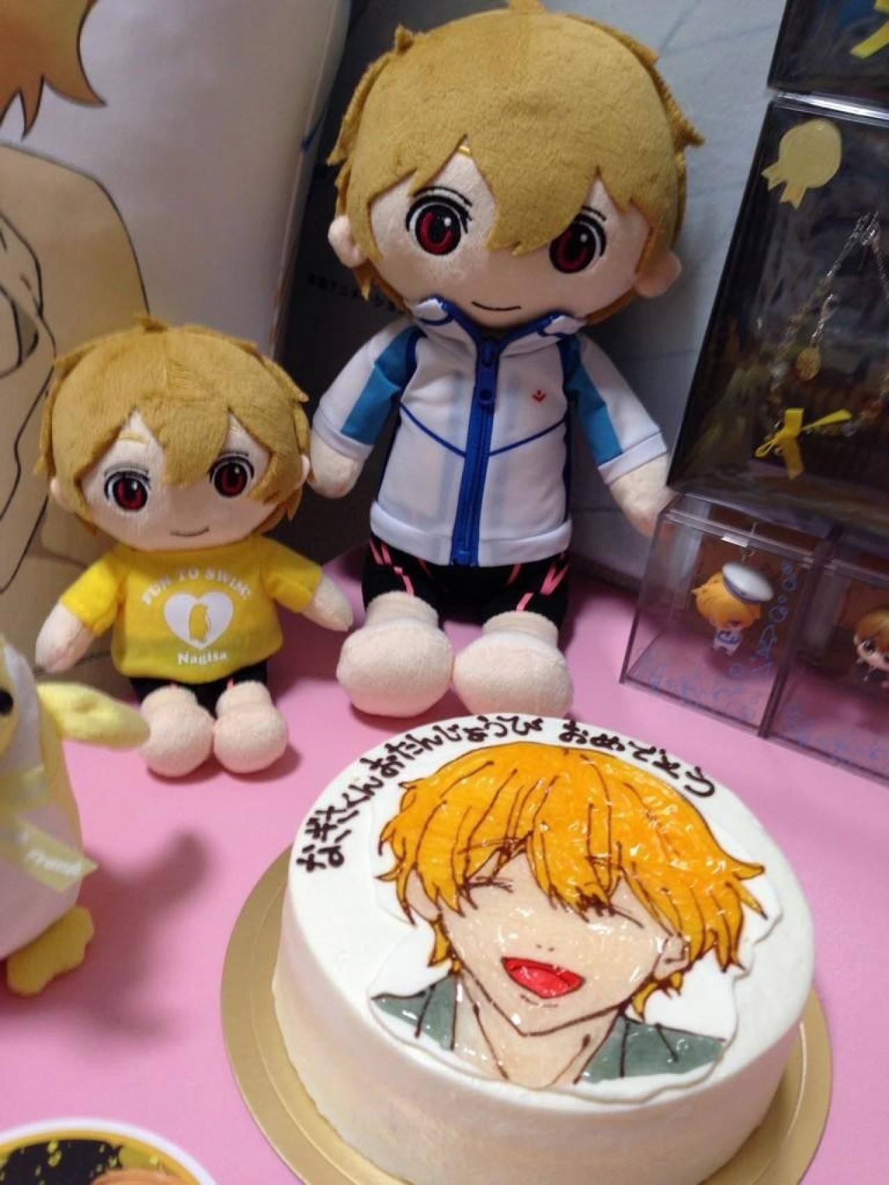 粉红的桌面上摆着叶月渚的玩偶和生日蛋糕