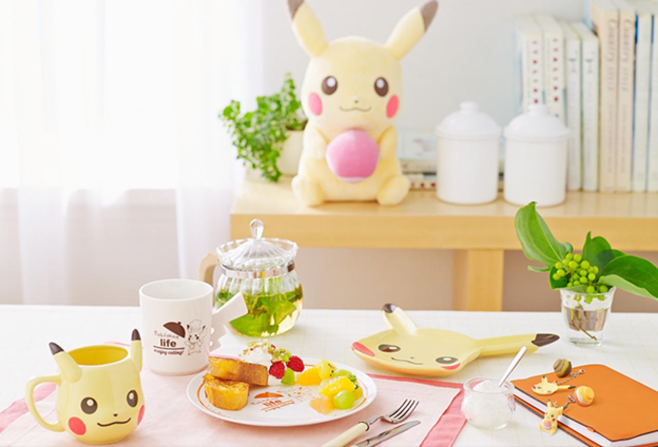 皮卡丘陶瓷碟、马克杯、手机链和毛绒玩具在餐桌上摆放的效果