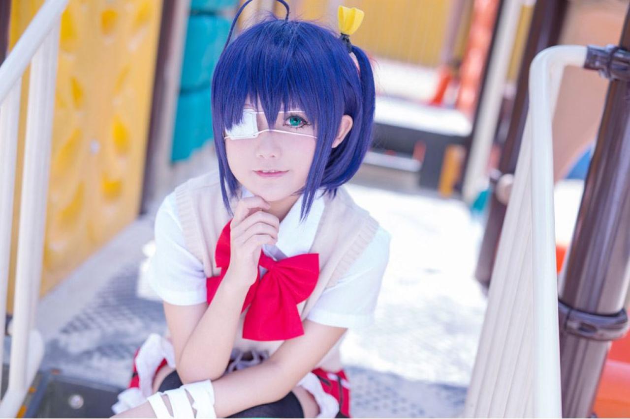 小野麻雀扮演小鸟游六花摸着下巴微笑