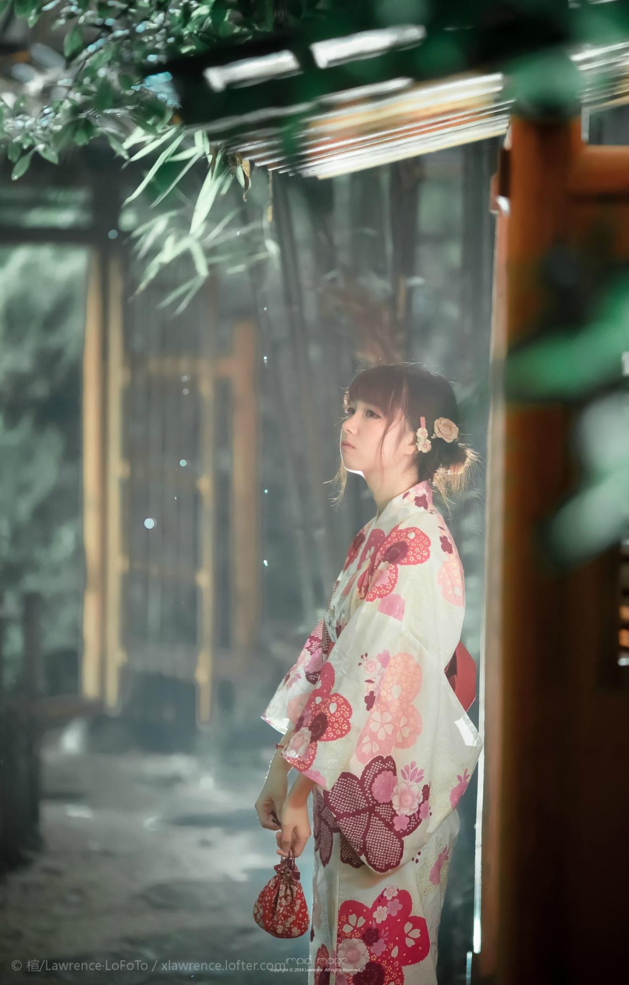 粉色和服浴衣少女拎着香包的侧面照