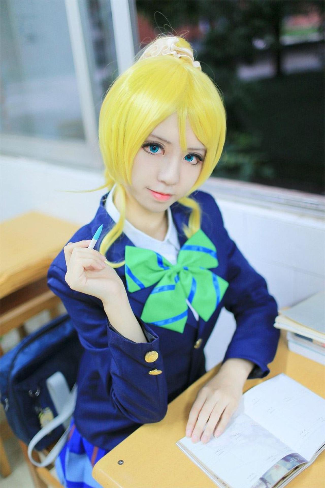 赤澤Aki扮演绚濑绘里在窗台的课桌上提笔准备写字