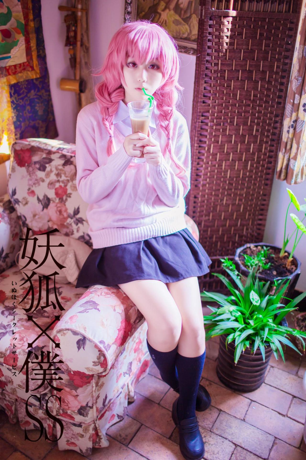 菌子扮演髅髅宫歌留多双手捧着奶茶杯靠在沙发扶手上，从杯子中吸饮料
