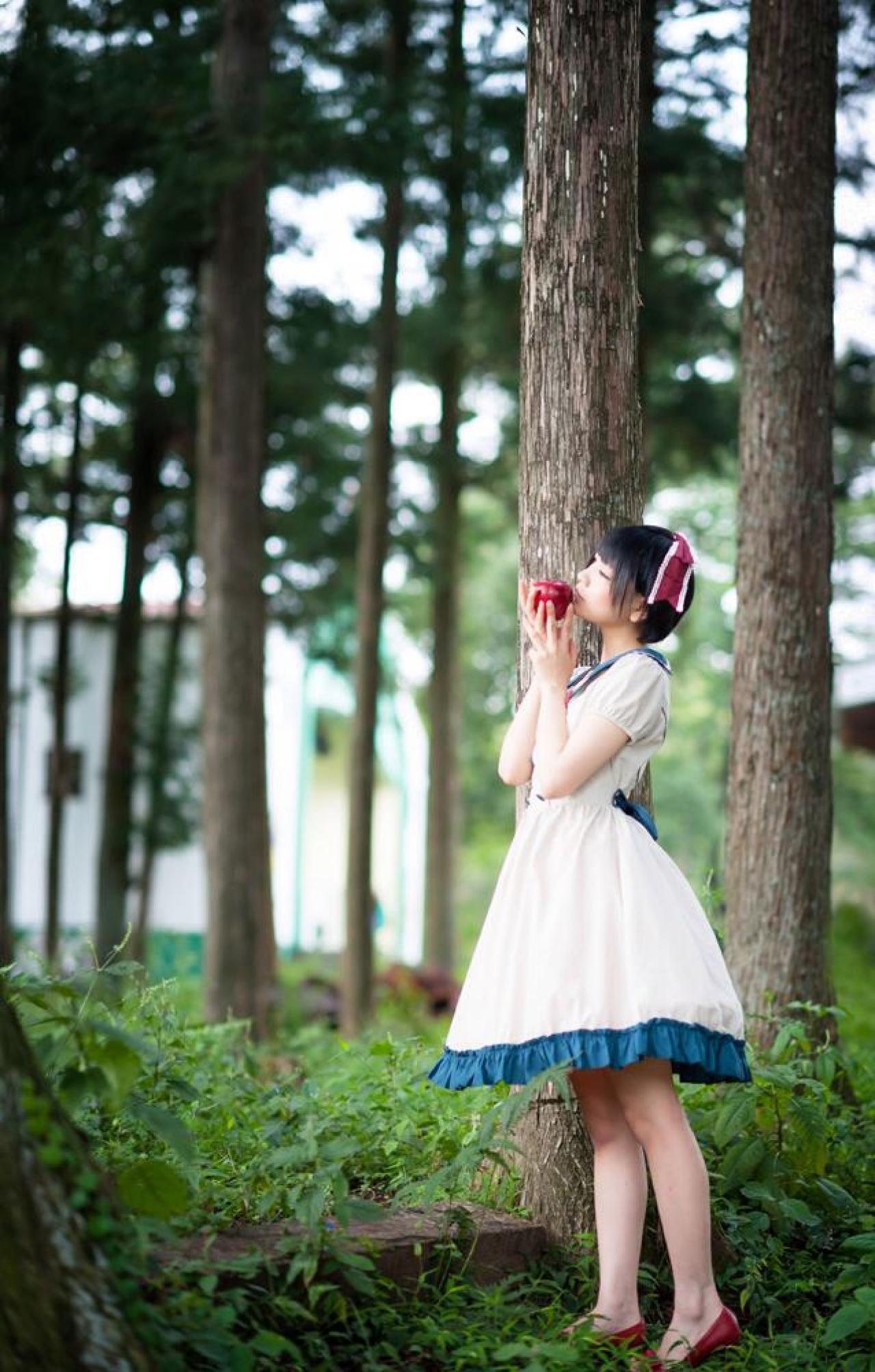 林间，Panzerella将苹果捧在唇边，侧身